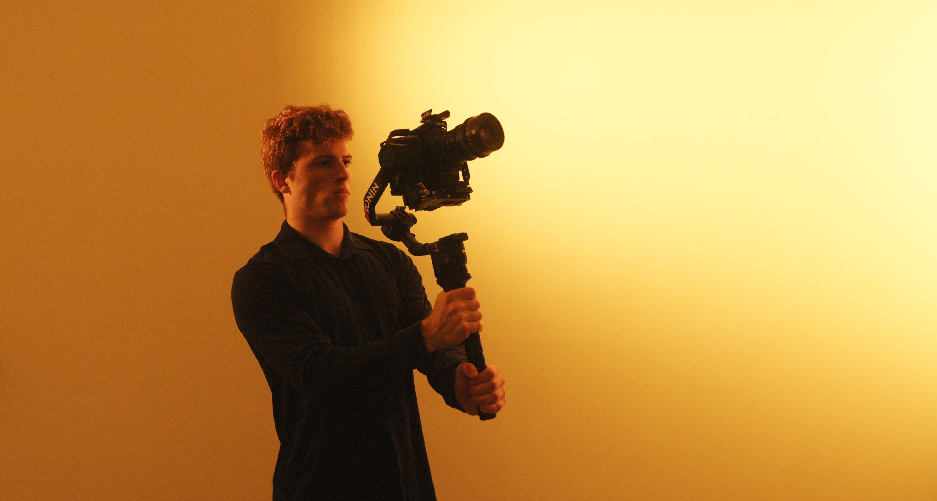 Daniele Giacobbe filming with a cinema camera on set